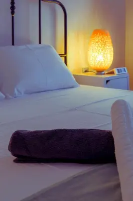 a bedroom with a bed with a purple blanket on it at Adorable 2 bedroom apartment close to Ancient Athens city center in Athens