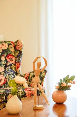 a wooden mannequin on a table in front of a couch at Adorable 2 bedroom apartment close to Ancient Athens city center in Athens