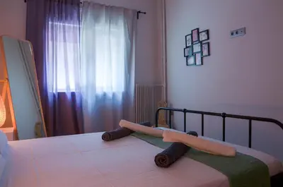 a bedroom with a bed with two towels on it at Adorable 2 bedroom apartment close to Ancient Athens city center in Athens
