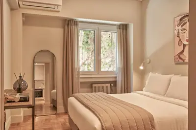 a hotel room with a bed and a window at Athenian Elite Kolonaki Apt in Athens