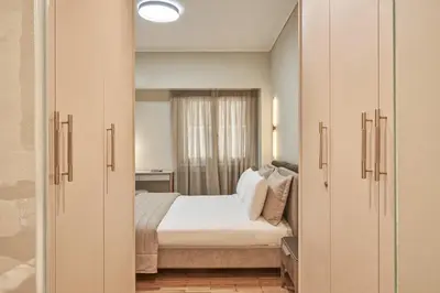 a bedroom with a bed and a large window at Athenian Elite Kolonaki Apt in Athens