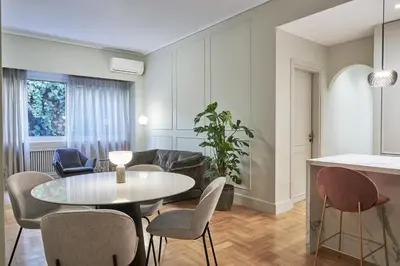 a living room with a table and chairs at Athenian Elite Kolonaki Apt in Athens