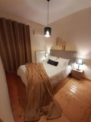 a bedroom with a bed with a blanket on it at Casa Nova - Appartment near the sea in Piraeus