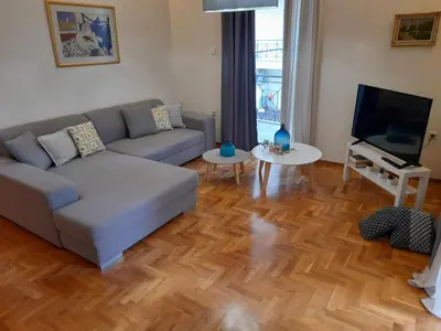 a living room with a couch and a television at Casa Nova - Appartment near the sea in Piraeus