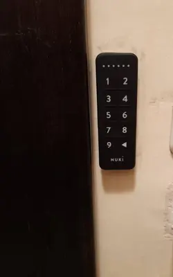 a black remote control on the side of a wall at Casa Nova - Appartment near the sea in Piraeus