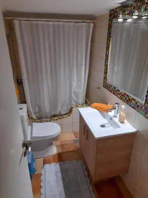 a bathroom with a toilet and a sink and a mirror at Casa Nova - Appartment near the sea in Piraeus