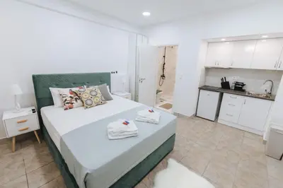 a bedroom with a large bed with towels on it at Your Cozy Sapphire Apartment VIPGreece in Athens