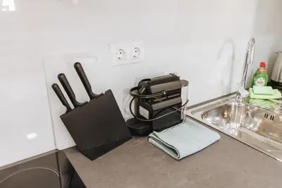 a kitchen counter with a sink with a bag on it at Your Cozy Sapphire Apartment VIPGreece in Athens