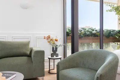 a living room with a couch and a chair at Altar Suites in Athens