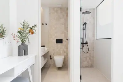 a bathroom with a shower and a toilet at Altar Suites in Athens