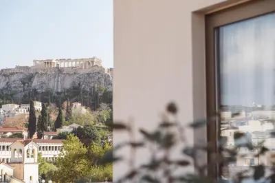 a view of the acropolis from a window of a building at Altar Suites in Athens