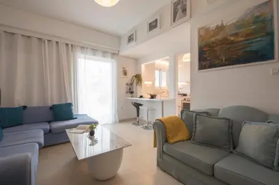 a living room with a couch and a table at Maria Louiza apartment close to the center in Athens