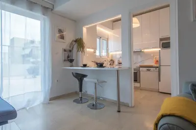 a kitchen with a counter and a bar in a room at Maria Louiza apartment close to the center in Athens