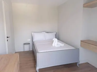a white bed with a towel on it in a room at Greek Dream Homes Thimari in Sounio