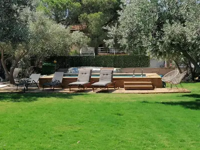 a group of chairs sitting next to a pool at Greek Dream Homes Thimari in Sounio