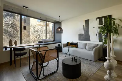 a living room with a couch and a table at Athens Woo Suites in Athens
