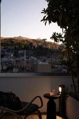 a room with a table and a chair and a window at Athens Woo Suites in Athens