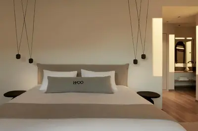 a bedroom with a large bed with a nos sign on it at Athens Woo Suites in Athens