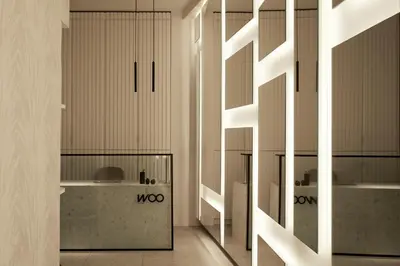 a room with white walls and a hallway with mirrors at Athens Woo Suites in Athens