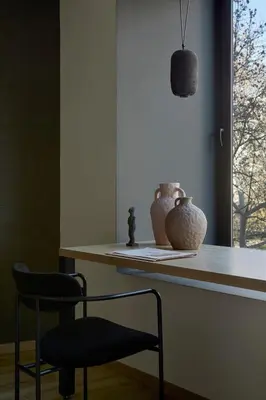 a chair and vases on a counter in a room at Athens Woo Suites in Athens