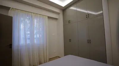 a bedroom with white cabinets and a window at New Ventiri Suite 3, near Hilton, Athens Central, fully equipped in Athens