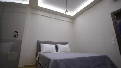 a bed with two pillows in a white room at New Ventiri Suite 3, near Hilton, Athens Central, fully equipped in Athens