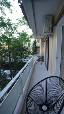 a balcony with a table and chairs on a building at New Ventiri Suite 3, near Hilton, Athens Central, fully equipped in Athens