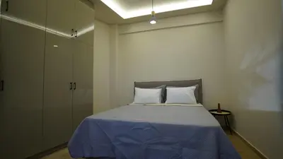 a bedroom with a bed with a blue blanket at New Ventiri Suite 3, near Hilton, Athens Central, fully equipped in Athens