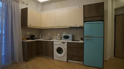a kitchen with a refrigerator and a washing machine at New Ventiri Family Suite 1, near Hilton, Athens central, fully equipped in Athens