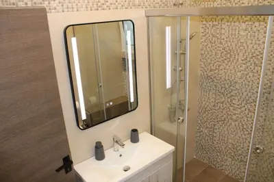 a bathroom with a sink and a shower with a mirror at New Ventiri Family Suite 1, near Hilton, Athens central, fully equipped in Athens
