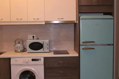 a kitchen with a refrigerator and a microwave at New Ventiri Family Suite 1, near Hilton, Athens central, fully equipped in Athens