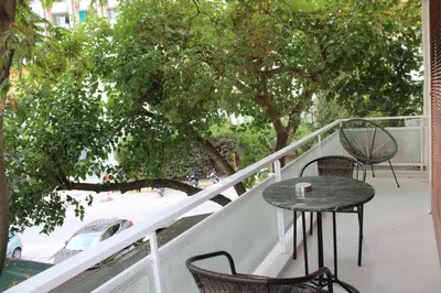 a patio with a table and chairs on a balcony at New Ventiri Family Suite 1, near Hilton, Athens central, fully equipped in Athens