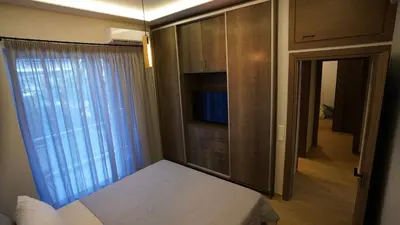 a bedroom with a tv and a bed and a window at New Ventiri Family Suite 1, near Hilton, Athens central, fully equipped in Athens