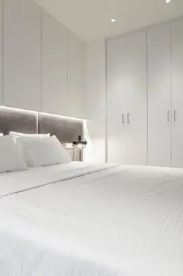 a white bed with white sheets and pillows at Ultra Chic Modern 4 Bedrooms Apartment in Athens in Athens