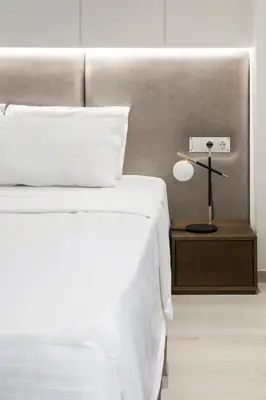 a bedroom with a bed and a lamp on a night stand at Ultra Chic Modern 4 Bedrooms Apartment in Athens in Athens