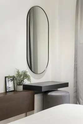 a mirror on a wall next to a bed at Ultra Chic Modern 4 Bedrooms Apartment in Athens in Athens