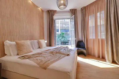 a bedroom with a large bed and a window at AthINN Residence in Athens