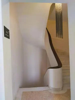 a staircase in a house with a sculpture on it at AthINN Residence in Athens