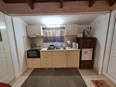 a small kitchen with a sink and a microwave at Semelia's Guest house in Spáta