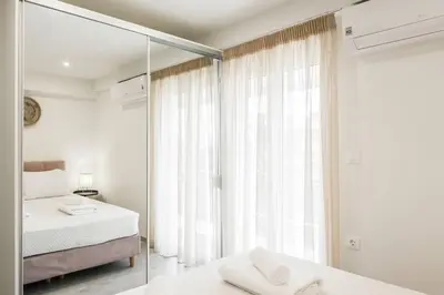 a bedroom with two beds and a mirror at 2BDR Athens Riviera Sea View Apartment by The Olon in Athens