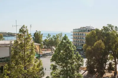 a group of trees in front of a building at 2BDR Athens Riviera Sea View Apartment by The Olon in Athens