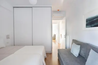 a bedroom with a bed and a couch at Wonderful Central Athens 2 Bedroom 2 Bath Sleeps 8 in Athens