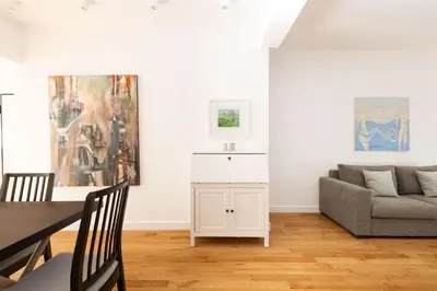 a living room with a table and a couch at Wonderful Central Athens 2 Bedroom 2 Bath Sleeps 8 in Athens