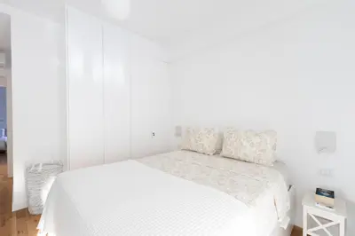 a white bedroom with a bed with white sheets at Wonderful Central Athens 2 Bedroom 2 Bath Sleeps 8 in Athens