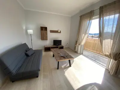 a living room with a couch and a table at Christy's House Anavissos / Ανάβυσσος in Anavissos