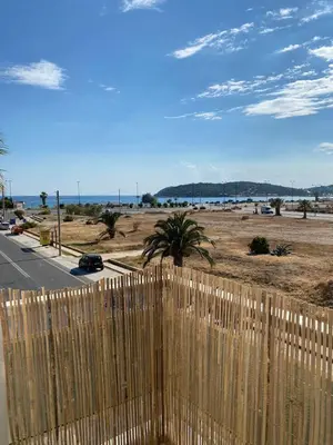 a wooden fence with a beach in the background at Christy's House Anavissos / Ανάβυσσος in Anavissos