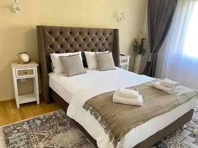 a bedroom with a large bed with two towels on it at Check Point - Acropolis View A in Athens