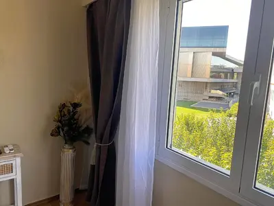 a window with a curtain and a vase of flowers at Check Point - Acropolis View A in Athens