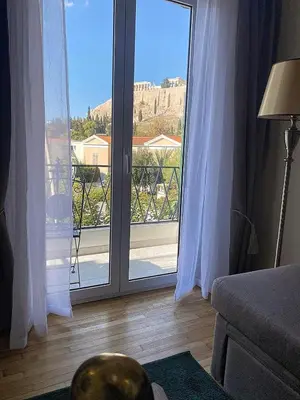 a living room with a large glass door with a view at Check Point - Acropolis View A in Athens