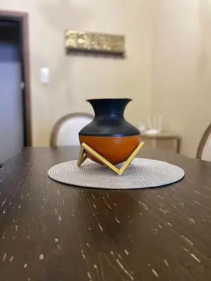 a black and orange vase sitting on a table at Check Point - Acropolis View A in Athens